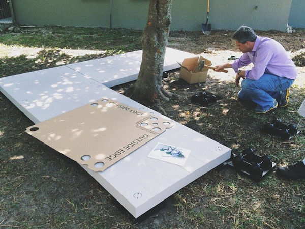 man installing a udecx patio deck